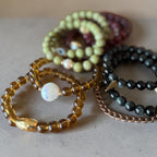 an assortment of bracelts that are fall colors. 