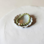 8mm Alaskan Avocado  (a green color) with fresh water pearl and gold spacers in a bracelet form.  