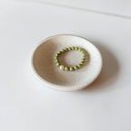 8mm Alaskan Avocado  (a green color) with fresh water pearl and gold spacers in a bracelet form.  
