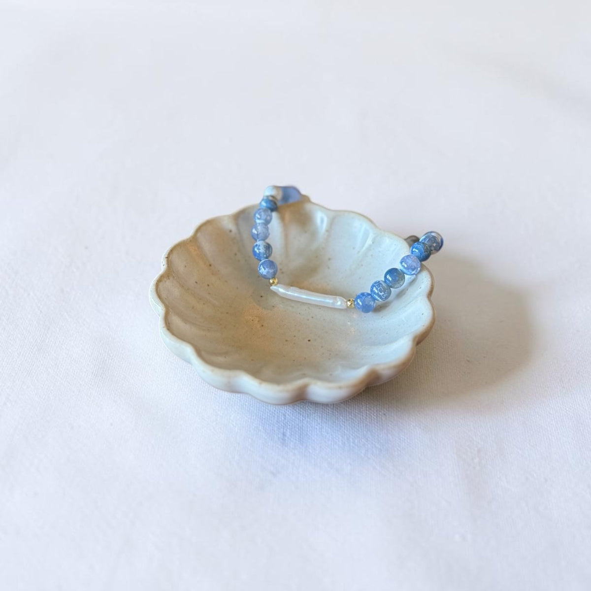 Blue Fire Agate, freshwater baroque pearl, and gold filled stretch bracelet by Poppies & Jules
