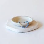 The Billie Bracelet shown from an angle, featuring Blue Fire Agate beads, a natural freshwater baroque pearl, and gold filled accents — Poppies & Jules