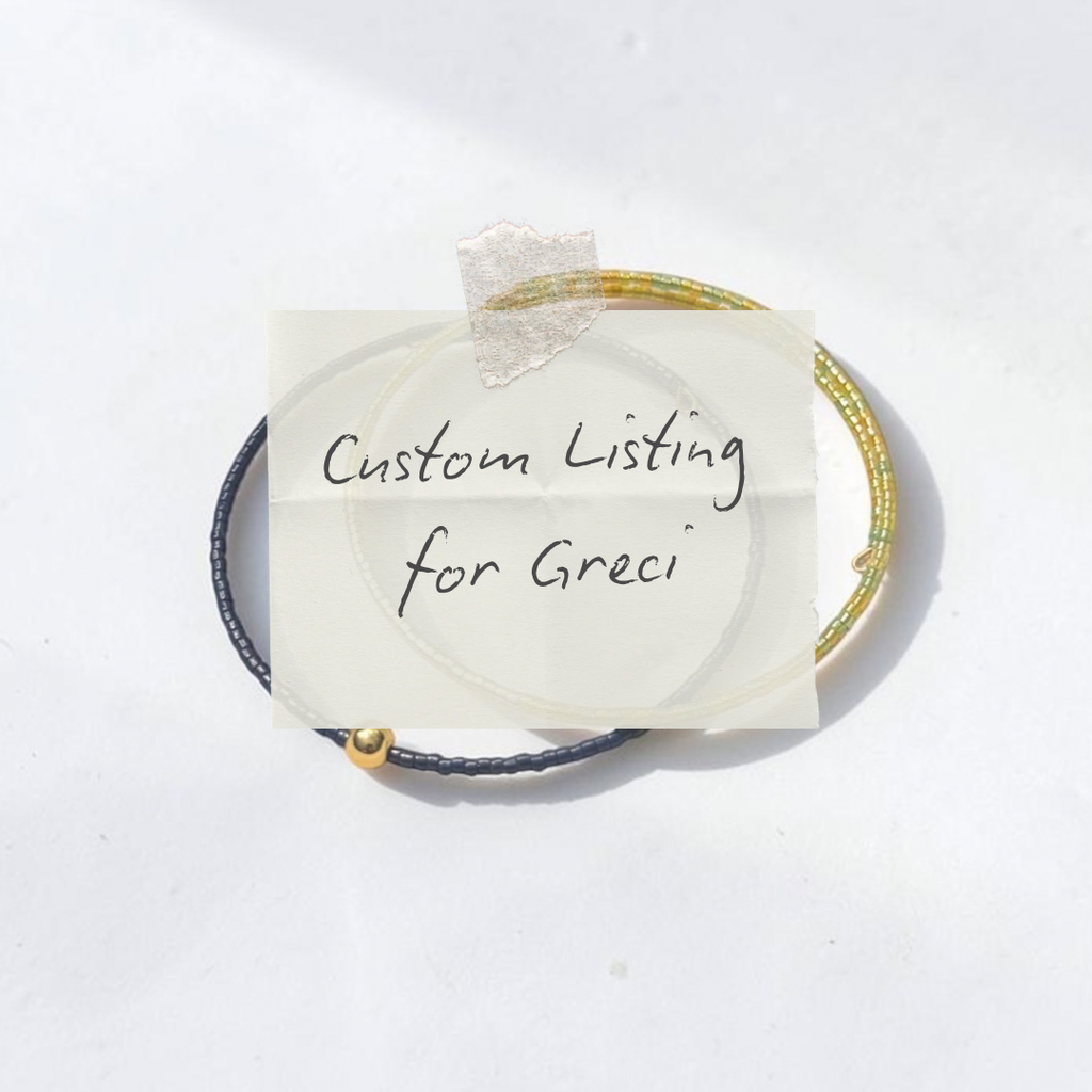 Two thin bangles or bracelets stacked together on a white surface, with a handwritten note taped over the center reading 'Custom Listing for Greci'. The bracelets appear to be the product, photographed in a clean studio-style setup with soft shadows.