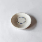 blue thin wire bracelet sitting in dish.