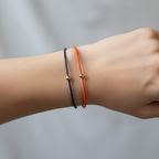lifestyle image of the Orange and Blue Rally Wire Bracelets on a wrist