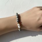 Dalmatian Jasper & Pearl Bracelet - Wrist Shot. This bracelet is sititng on an arm. It has spotted beads, gold filled beads and pearls. 