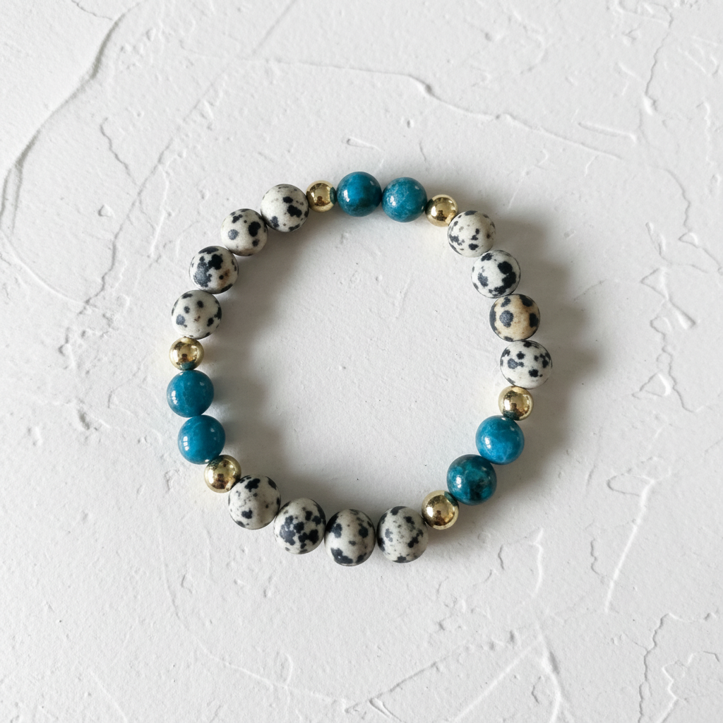 The Dottie Bracelet - White Background with texture with a bead bracelet zoomed in.