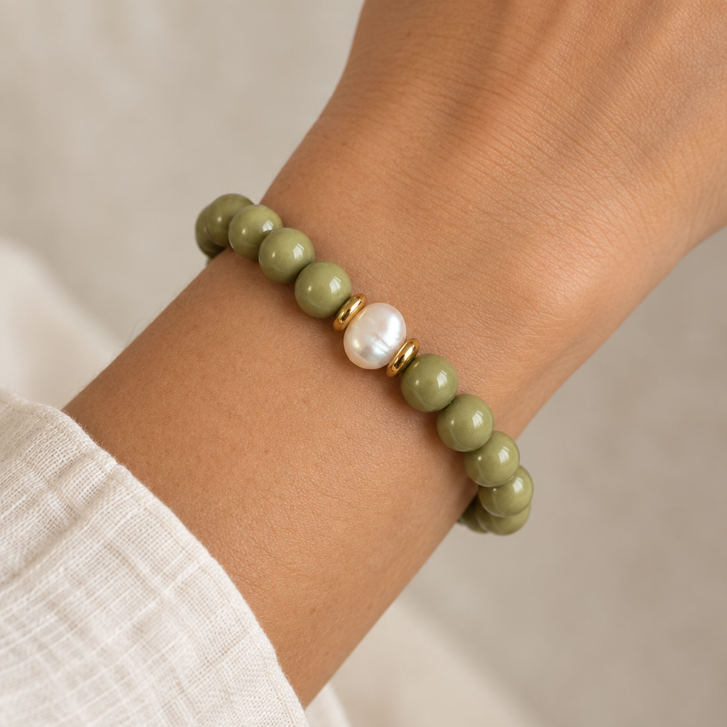 The Foxx Bracelet worn on a wrist. An up and down pearl with gold spacers is in the middle. 