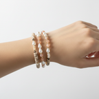 The Jules Bracelet wrist shot. a close up of 3 bracelets in various gemstones, pearls and looks.