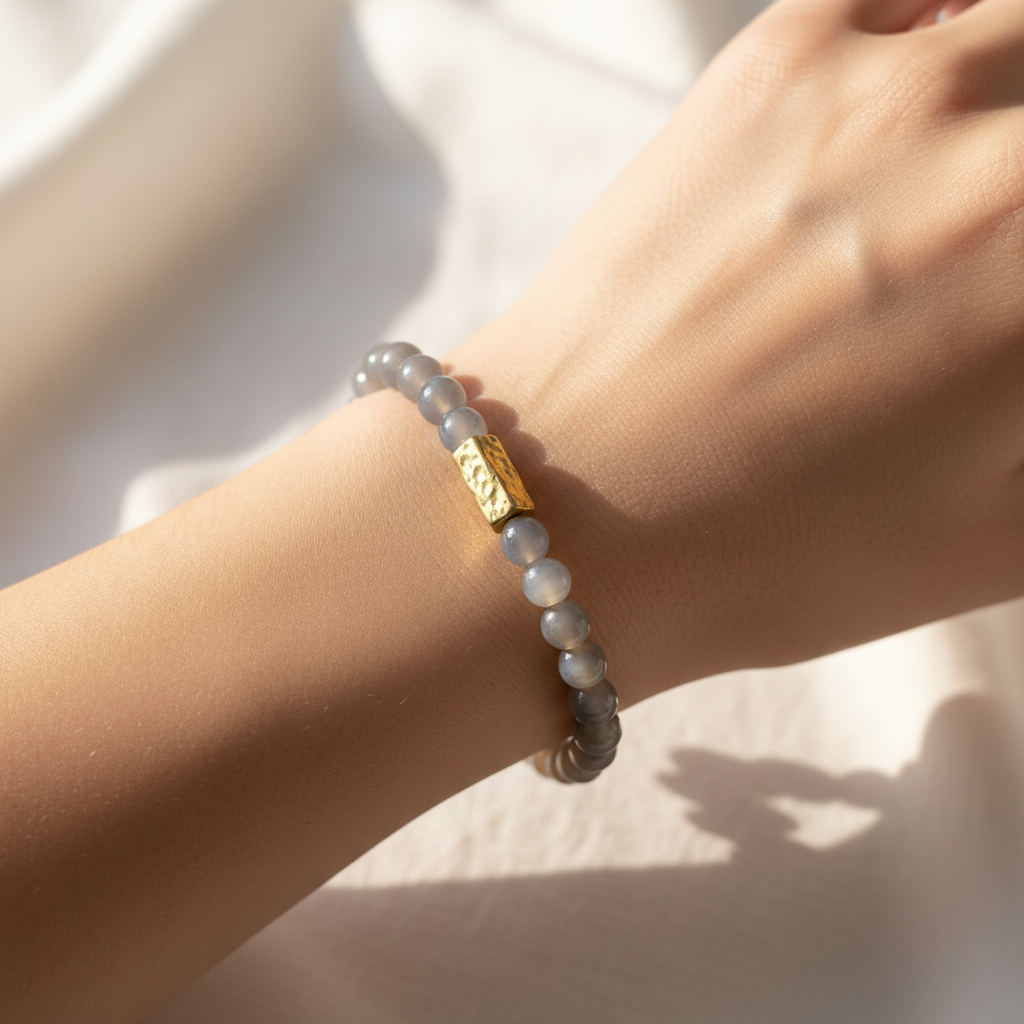 A close up of The Marlowe Bracelet on a womens wrist. The color is a gray mystic shade.