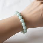 The Seren Bracelet on wrist shot. This shows a close up wrist of a female. The mint swirl of a bead bracelet sitting on the wrist.